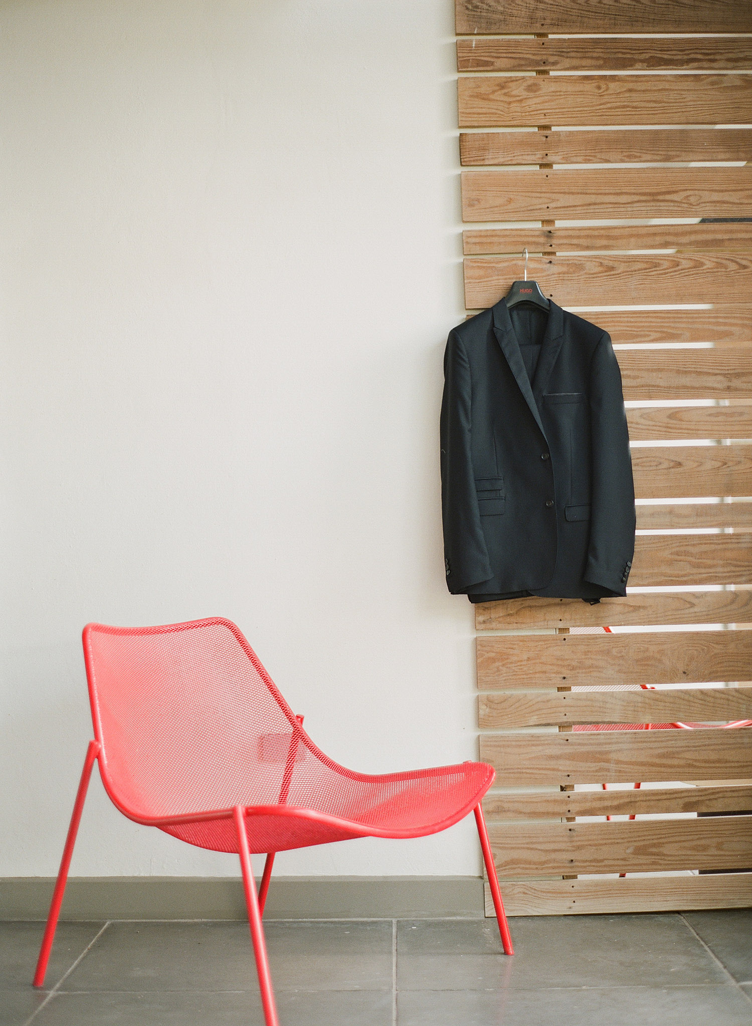 the groom's jacket hangs outside his room at this destination wedding in vieques island at the W hotel while destination wedding photographer, Lexia Frank, a film photographer shooting destination weddings worldwide photographs their vieques island wedding on film 