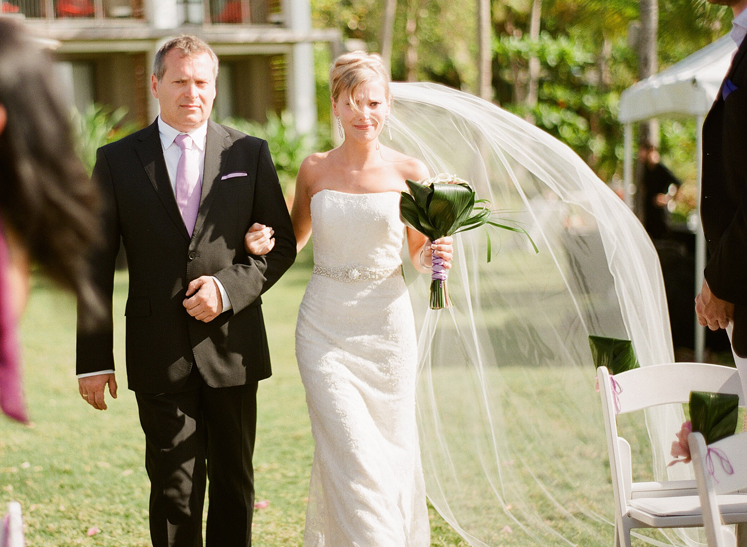 bride walks down the aisle crying at her Vieques ISland wedding at the W hotel. the wind catches her veil as Destination Wedding Photographer Lexia Frank photographs their wedding on film, as she is a destination wedding photographer and film photographer 