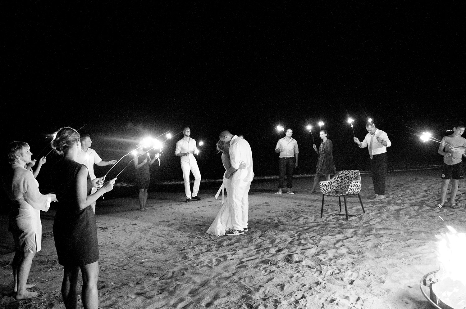 the couple shares a first dance on the beach surrounded by sparklers and a bonfire at the modern vieques island wedding at the w hotel in puerto rico photographed by destination wedding photographer Lexia Frank - a film photographer for weddings 