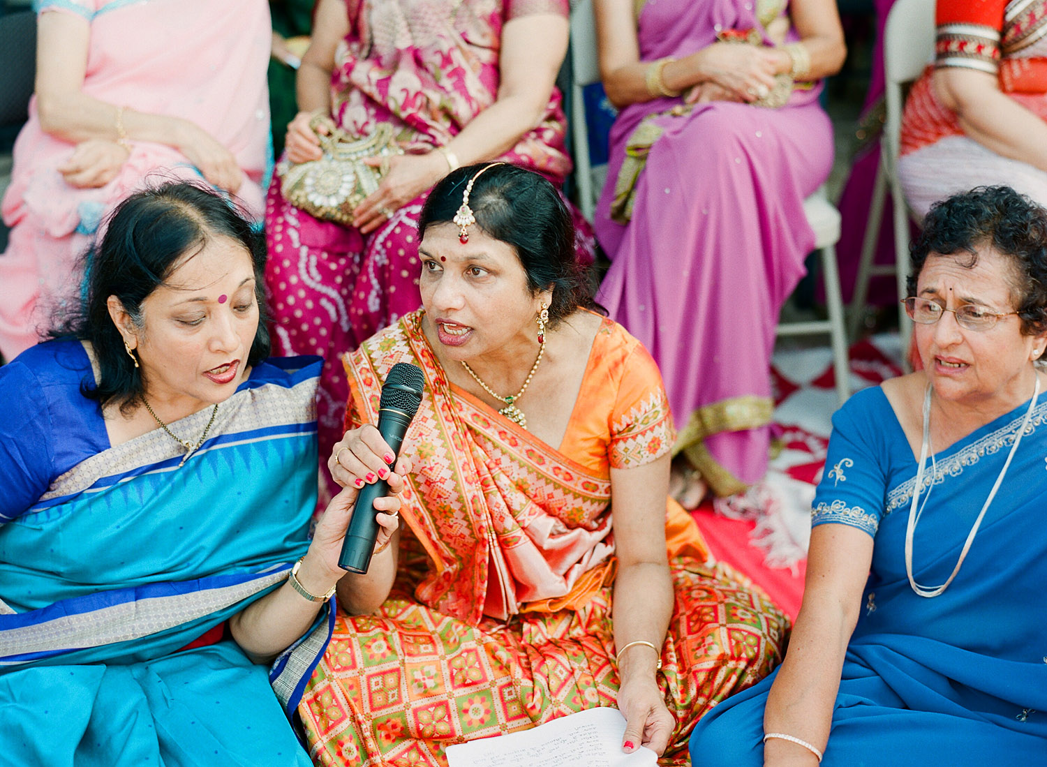 aunties sing at this hindu wedding in palm coast florida at the hammock beach resort photographed by Destination Wedding Photographer Lexia Frank, a top indian wedding photographer photographing her indian weddings on film and medium format film cameras and shooting luxury indian weddings worldwide 