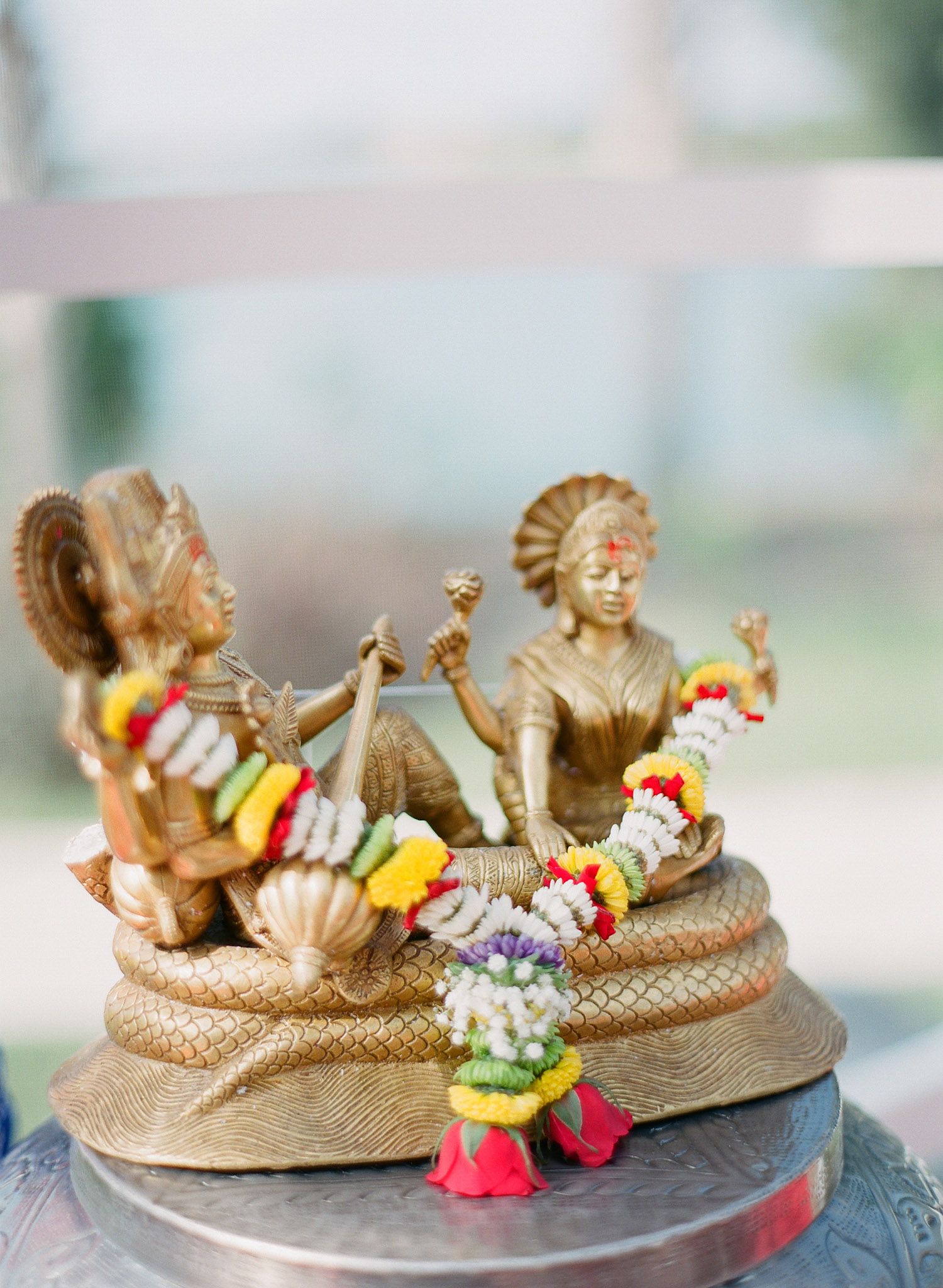 indian statue at a hindu wedding ceremony- the pithi ceremony, in palm coast florida at the hammock beach resort where destination wedding photographer Lexia Frank photographs this indian wedding on film using medium format film cameras to photograph luxury indian weddings worldwide 