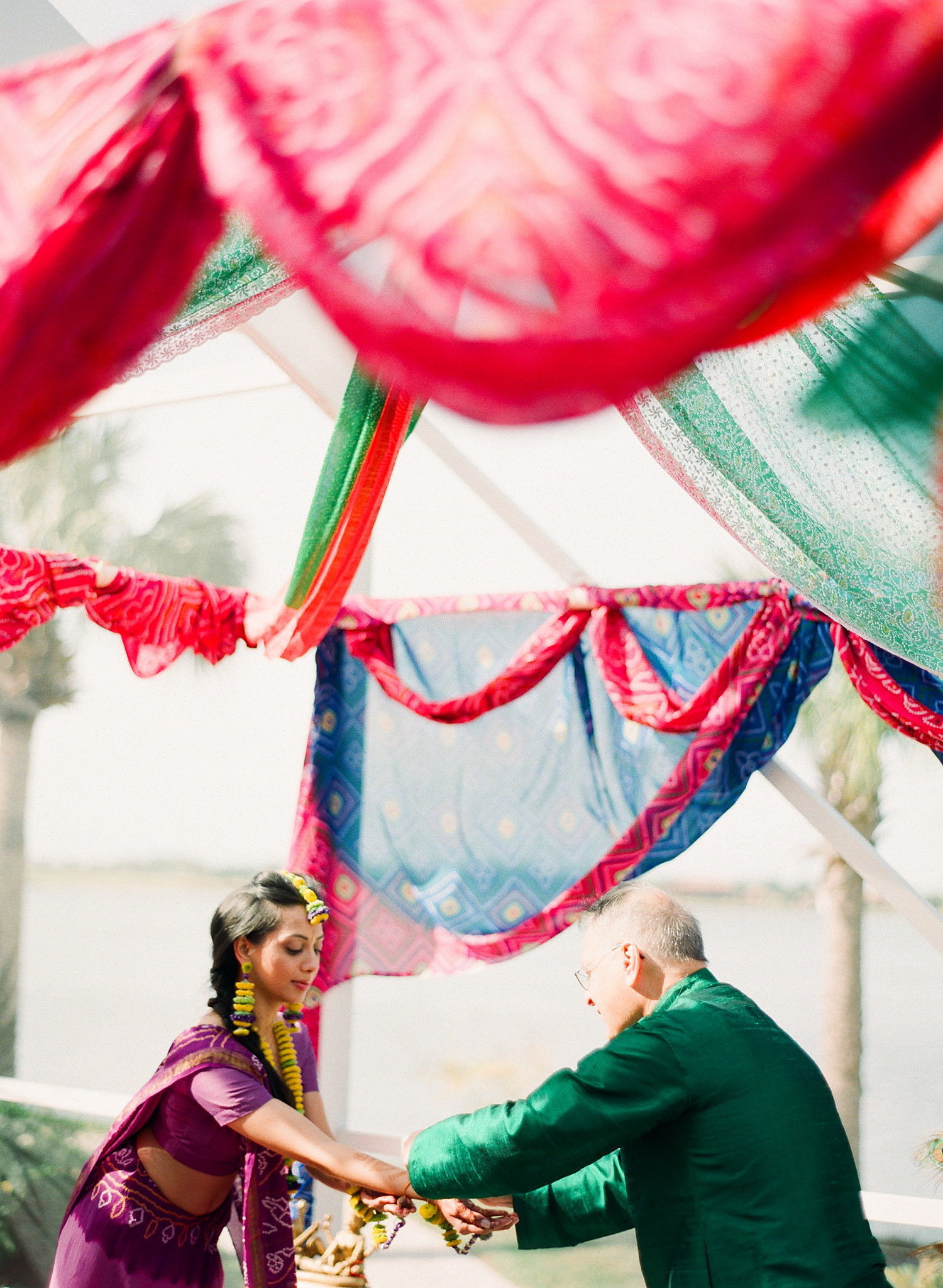 indian bride at her pithi ceremony at the hammock beach resort in palm coast florida wears floral indian wedding jewelry and floral jewelry like a floral tikka and floral earrings while Destination Wedding Photographer LExia Frank - rated best indian wedding photographer, photographs her indian wedding on film because she is a film photographer who shoots indian weddings on medium format film and medium format film cameras 