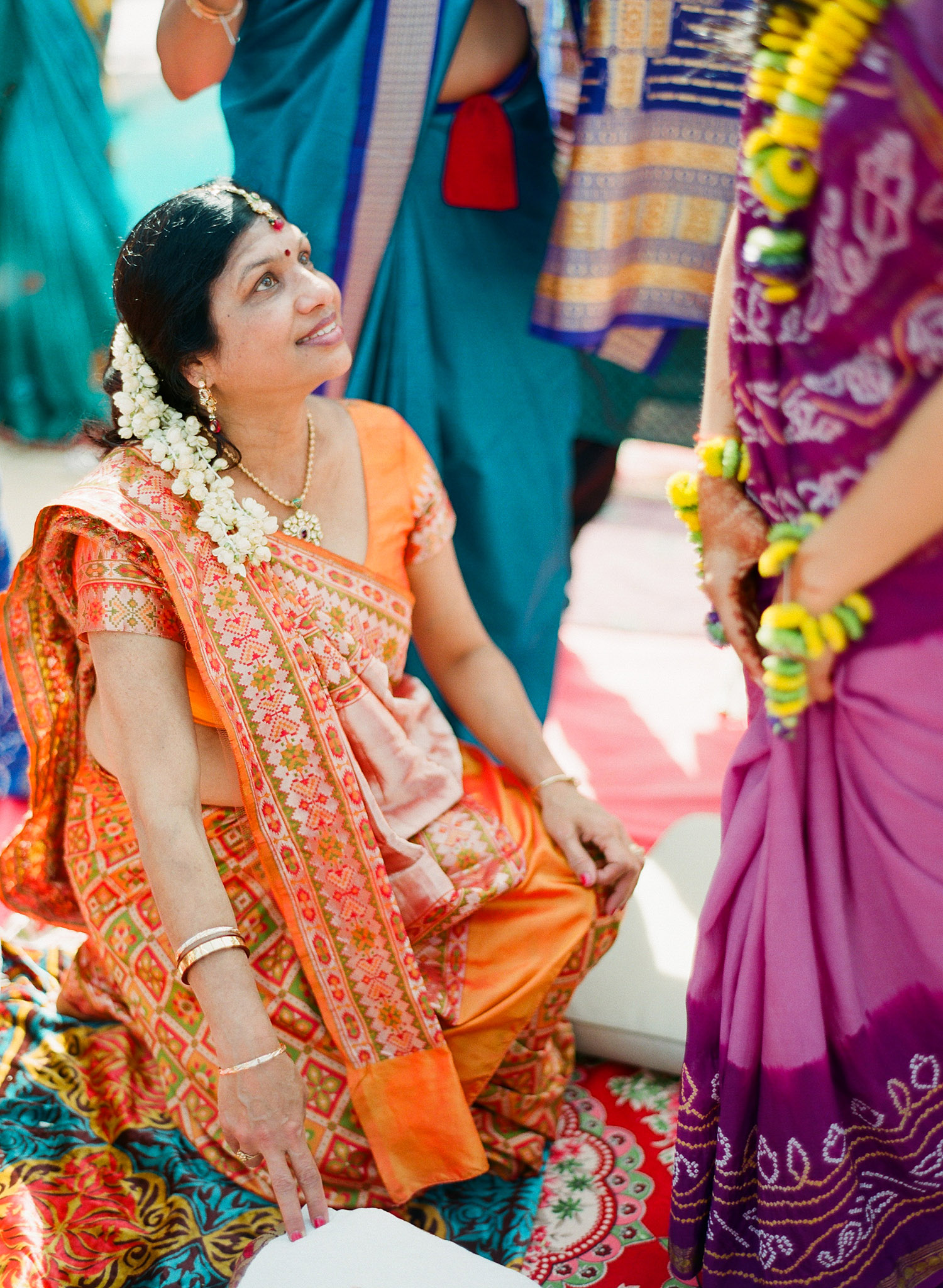 aunties help indian bride during her hindu pithi ceremony in palm coast florida while destination wedding photographer Lexia Frank - rated best indian wedding photographer - photographs this luxury indian wedding on film because she is a film photographer in florida for luxury weddings 