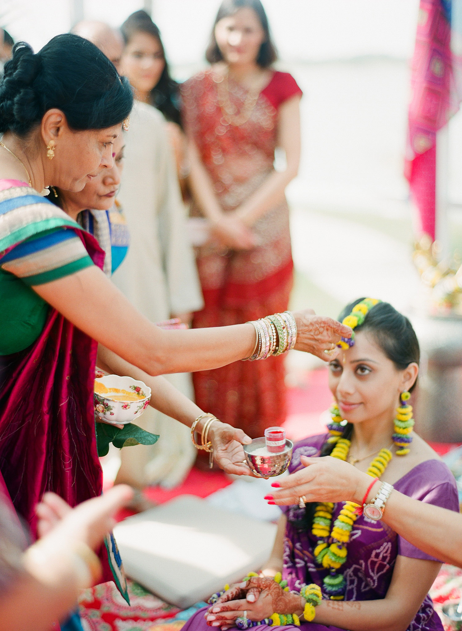 the bride at her pithi ceremony during this hindu wedding in florida while the bride wears floral indian wedding jewelry and Destination Wedding Photographer - Lexia Frank - a top indian wedding photographer, photographs this wedding on film because she is a film photographer who shoots luxury weddings worldwide 