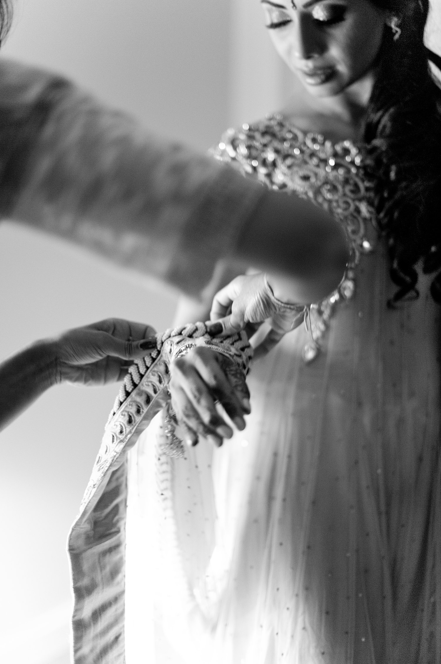 beautiful indian wedding bride adjusts her saree for her hindu wedding in palm coast florida photographed by Destination Wedding Photographer, Lexia Frank, ranked top indian wedding photographer in the United States and India who photographs her luxury indian wedding on film because she is a film photographer who shoots indian weddings on film in florida and worldwide for brides who love maharani weddings, South Asian Bride Magazine, and Manish malhotra 
