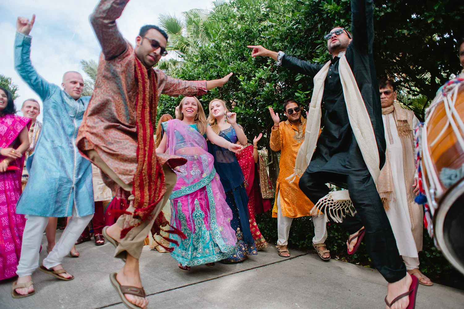 people dance at the parade at this Indian Wedding in Florida photographed by Destination Wedding Photographer, LExia Frank - a top indian wedding photographer - who shoots film for luxury indian weddings preferring the soft skin tones and vibrant colors for indian weddings in india and worldwide