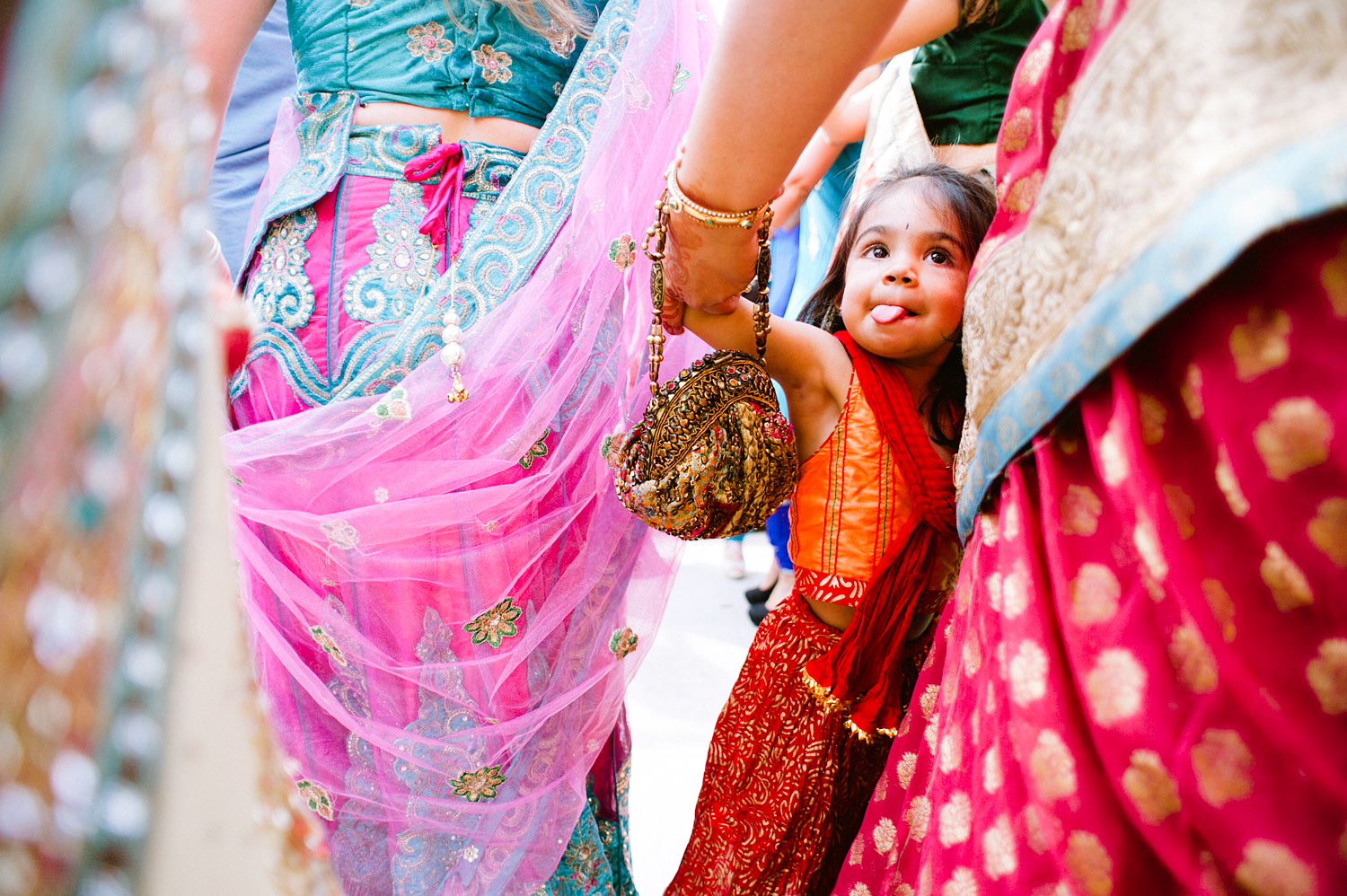 little girl dances during the parade at this Indian Wedding in Florida photographed by Destination Wedding Photographer, LExia Frank - a top indian wedding photographer - who shoots film for luxury indian weddings preferring the soft skin tones and vibrant colors for indian weddings in india and worldwide