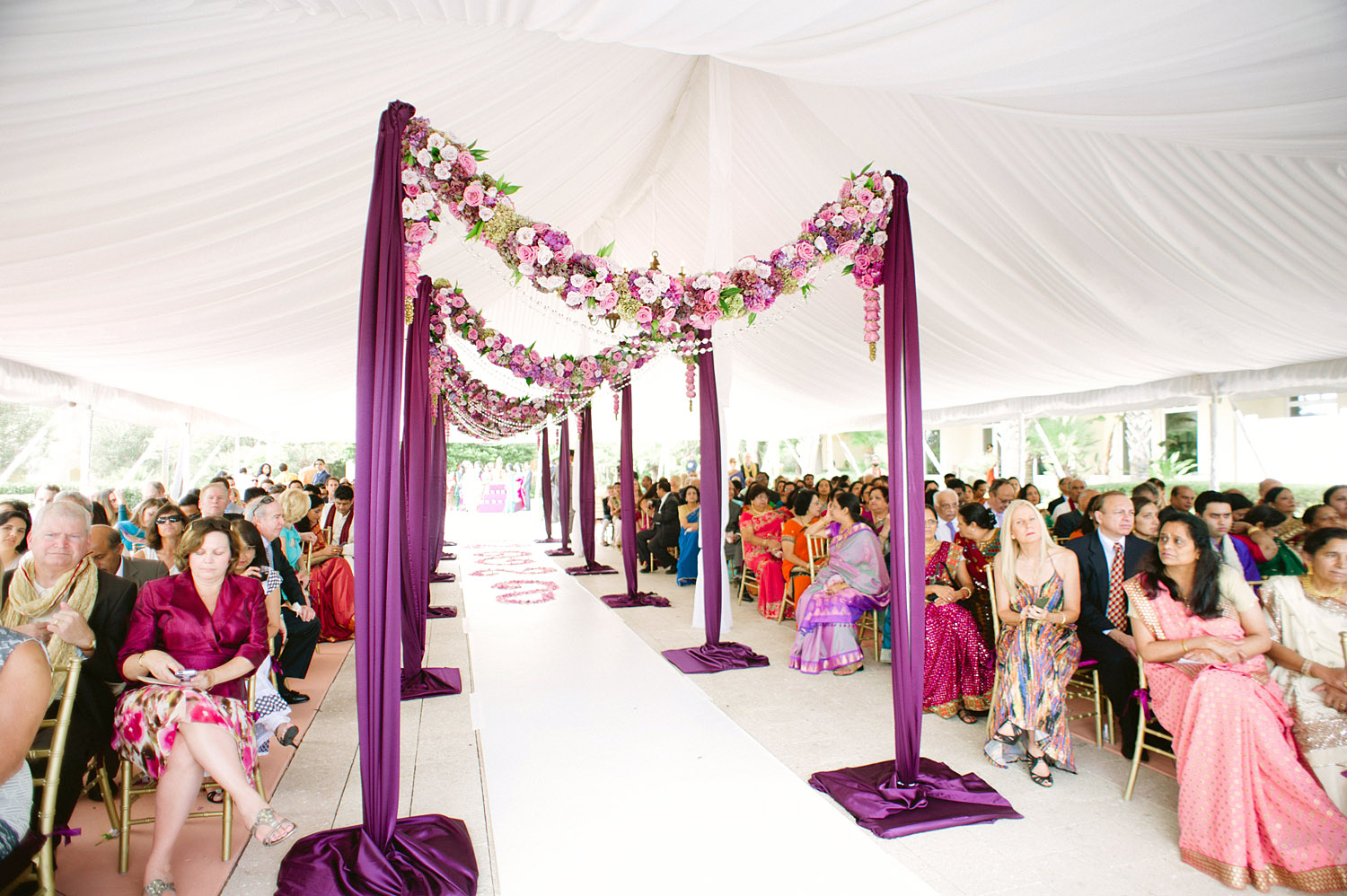 the isle was decorated with boughs of flowers leading up to the mandap at this Indian Wedding in Florida photographed by Destination Wedding Photographer, LExia Frank - a top indian wedding photographer - who shoots film for luxury indian weddings preferring the soft skin tones and vibrant colors for indian weddings in india and worldwide