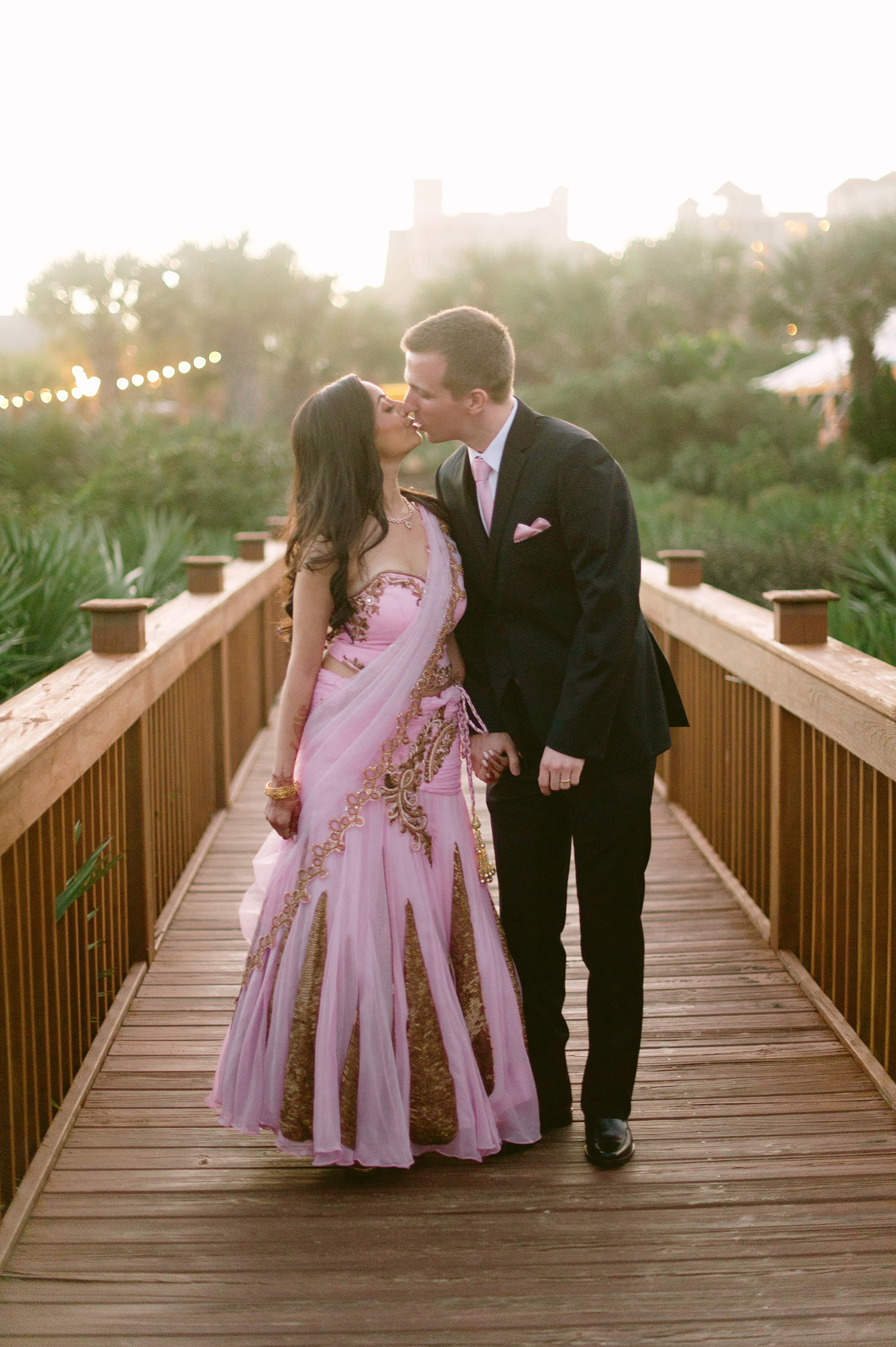 indian bride wears a pink and gold wedding lengha for her indian wedding in florida on the beach in palm coast florida as Destination Wedding Photographer Lexia Frank - an award winning indian wedding photographer - photographs her indian wedding on film, as she is a fine art wedding film photographer for destination weddings and luxury weddings worldwide. vizcaya miami wedding, hammock beach resort wedding. 