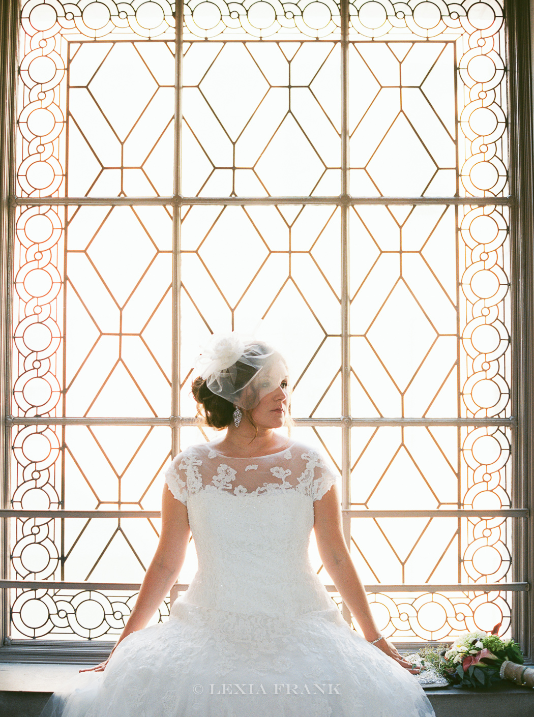 destination wedding photographer Lexia Frank - a portland fine art film photographer - photographs this san francisco city hall wedding in san francisco with bride wearing a bird cage veil and tea length wedding dress with lace cap sleeves . www.lexiafrank.com 