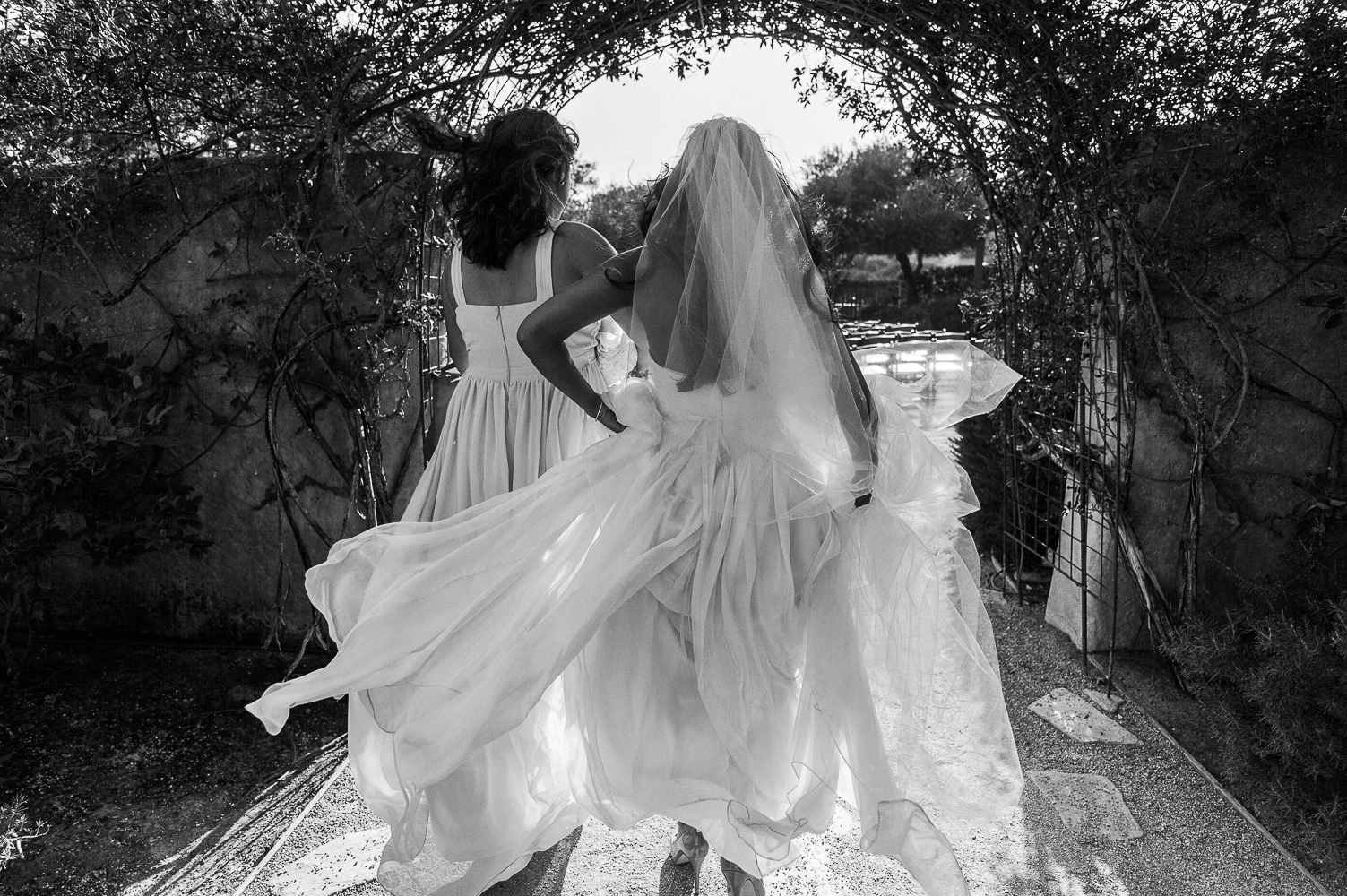 Destination wedding photographer Lexia Frank is a portland oregon fine art wedding photographer. bride walks through the entrance at her sunstone winery wedding in california. www.lexiafrank.com