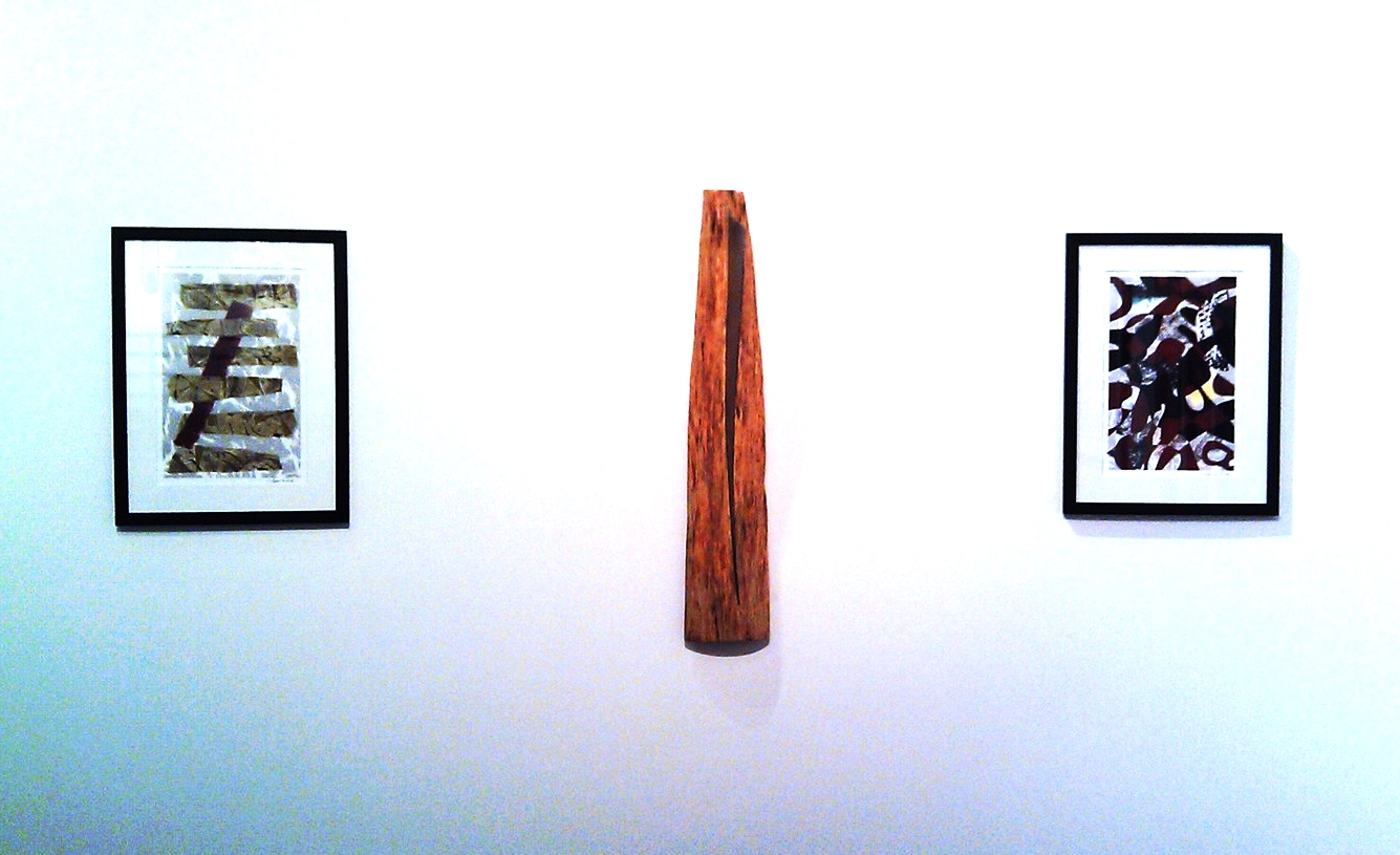 Sculpture flanked by two monoprints