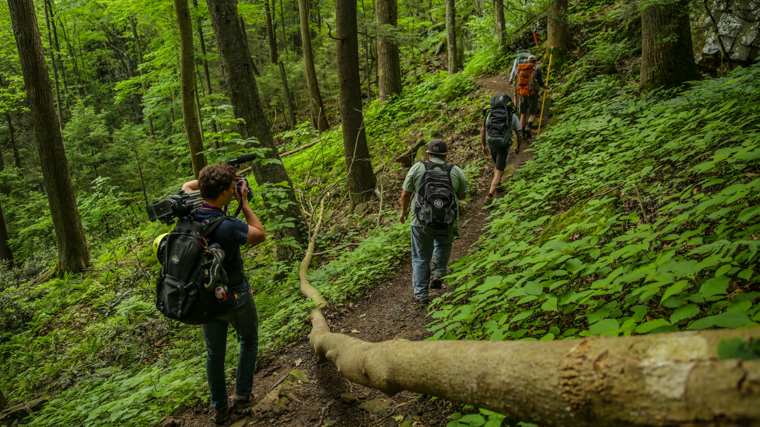 Climber and Filmmaker, Nate Spicer captures the first group of sanctioned climbers at Breaks as they head toward the routes along Prospector Trail. Photo: Gerry Seavo James 