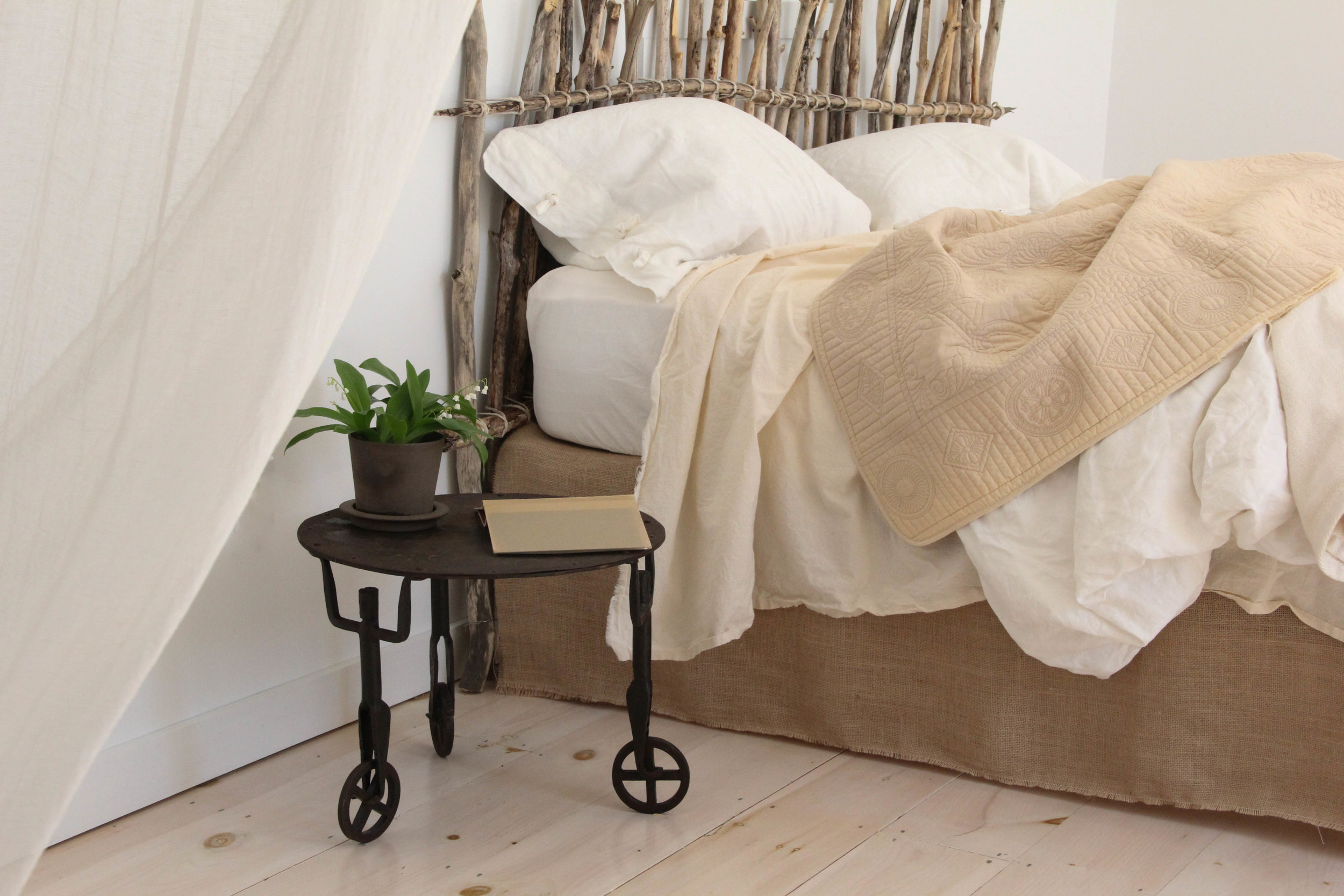 simple bedroom with twig headboard