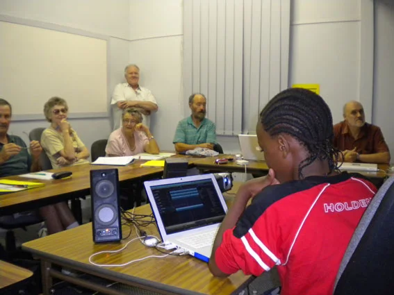 Kenneth (Year 7) tutoring some more experienced Mac users in the art of Garageband (Photo M. Jesser).