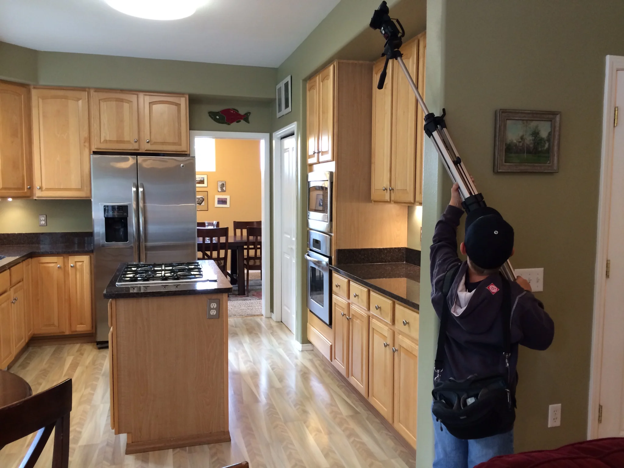 Dayton holding a flash to get more light into the kitchen