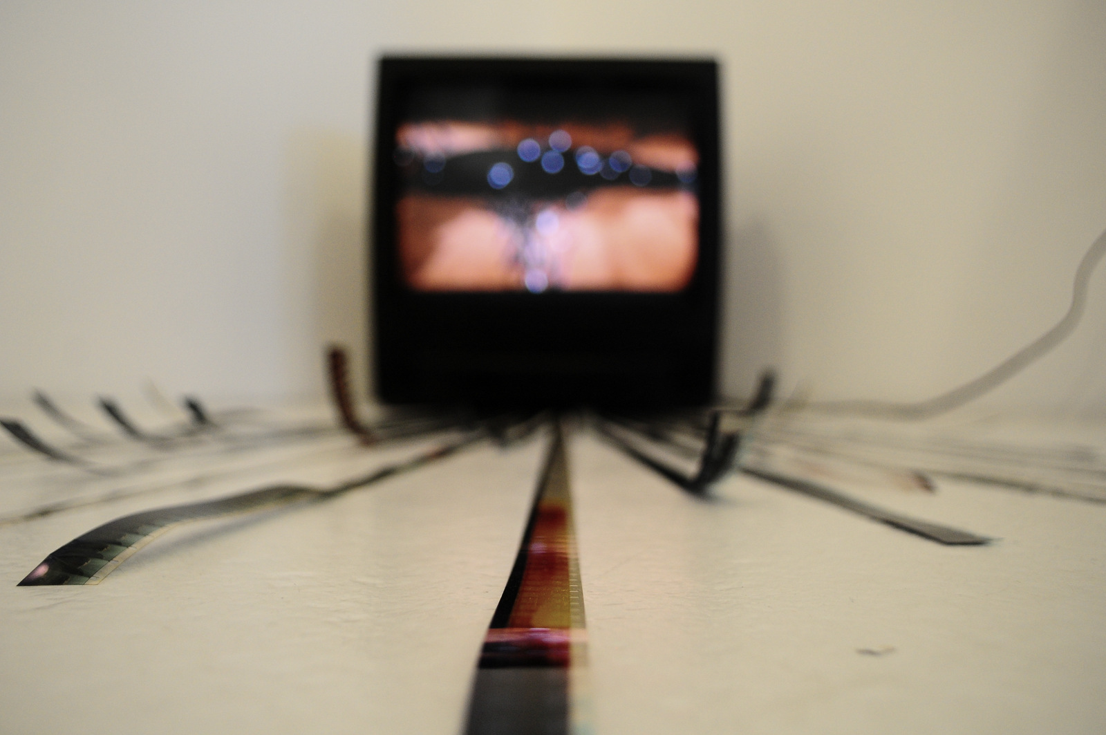 ‘Möbius' Video installation / TV, 16mm film strips, black acrylic paint.
