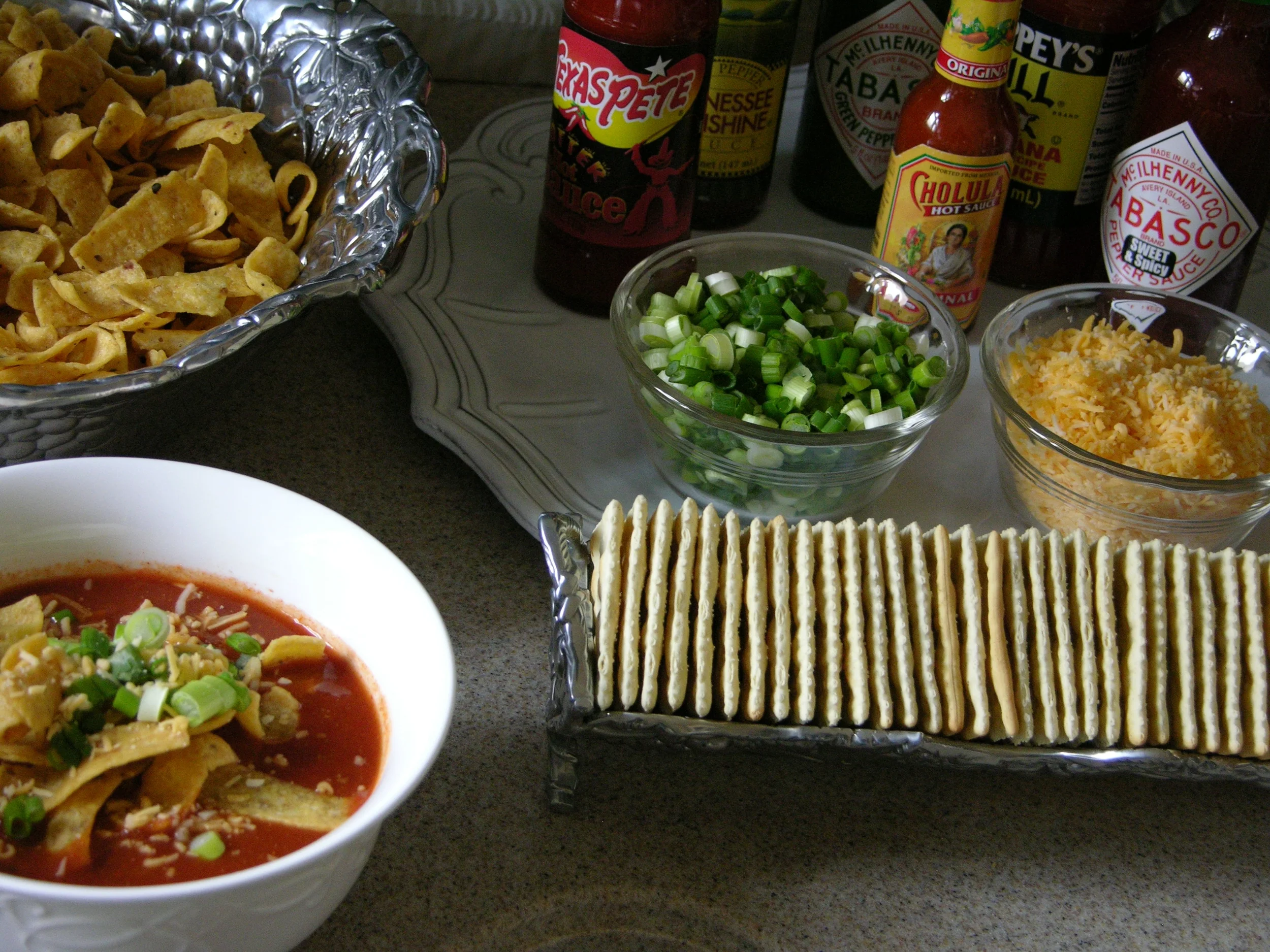 Set up a condiment station with hot sauces, crackers, and other toppings.