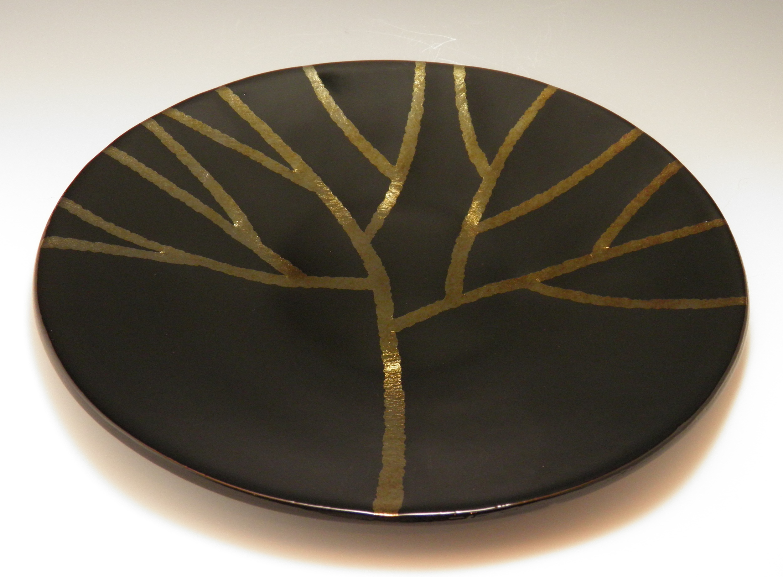 gold iridescent tree on black platter