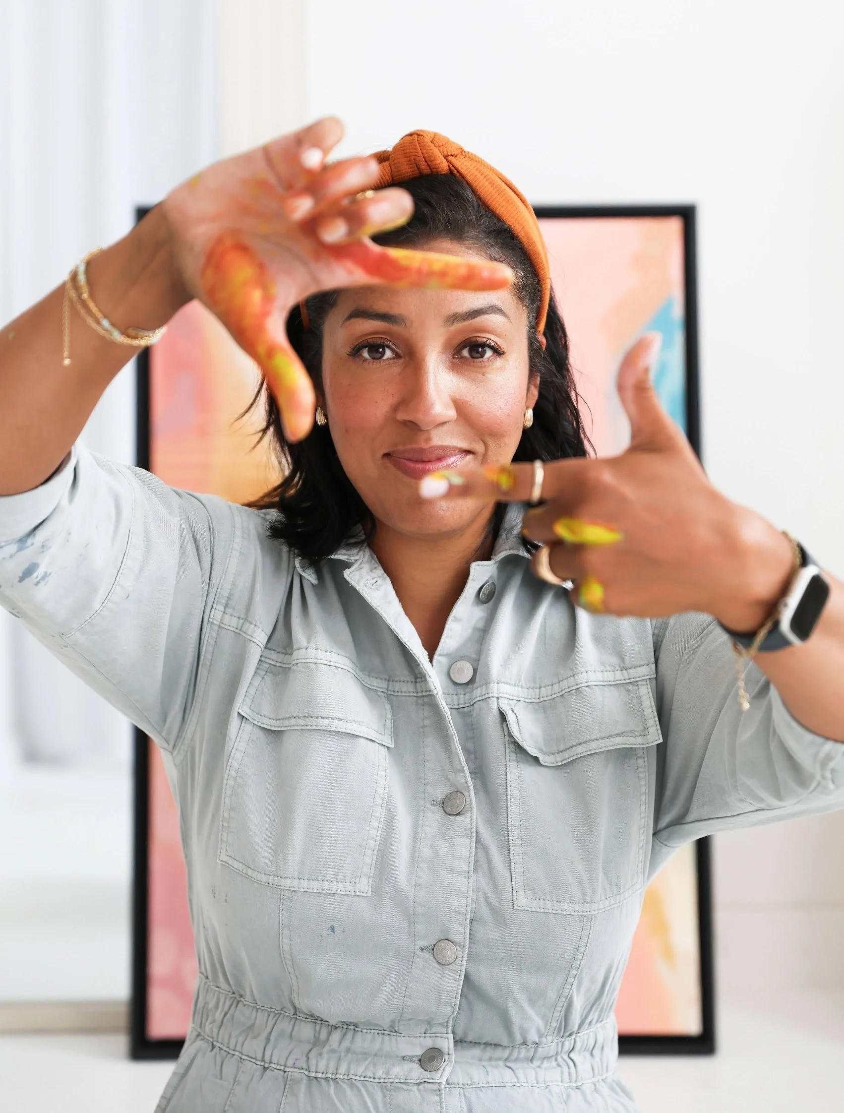 Nel, artist behind Paintings by Nel, paint-covered hands framing the shot in her studio