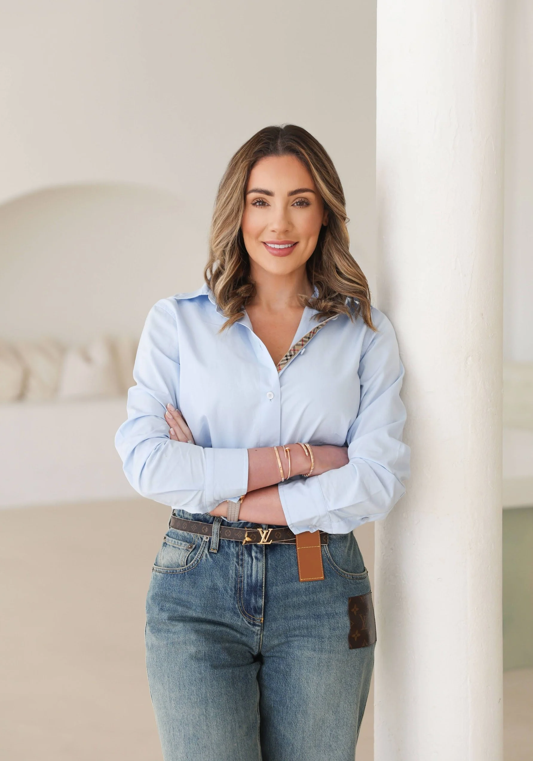Chloe Ainscough, Managing Director of Kensite, standing portrait against a white pillar