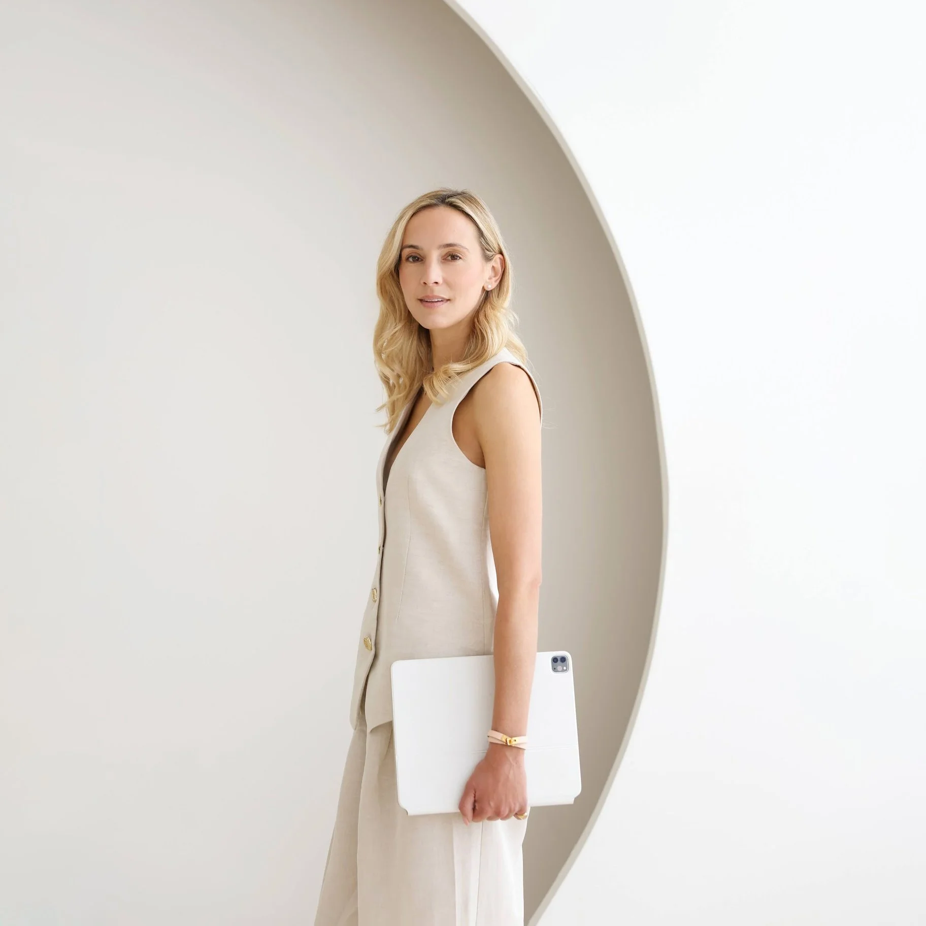 Emily Strickland, marketing strategist and growth partner, standing portrait holding a laptop