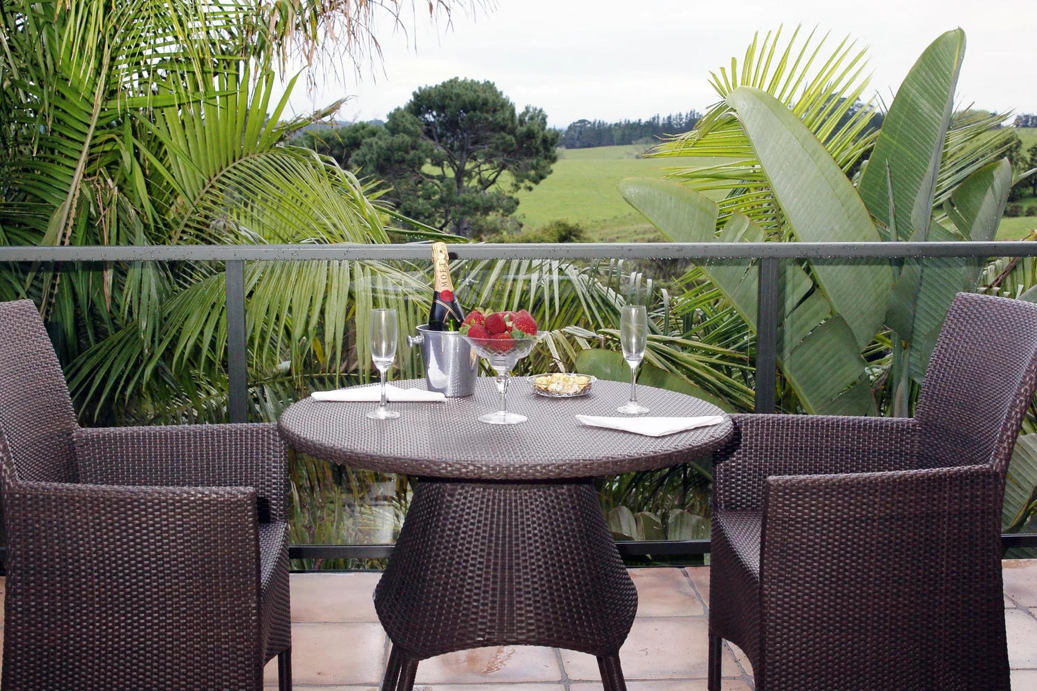 Balcony dining table set for two, looking out over the fairways