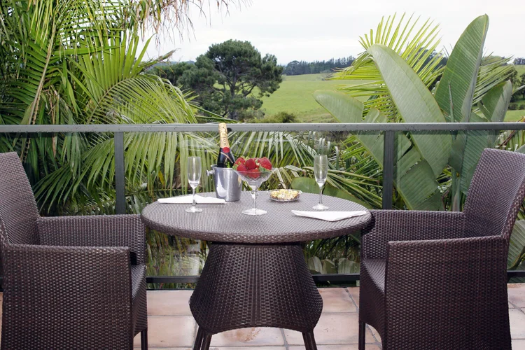 Balcony dining table set for two, looking out over the fairways
