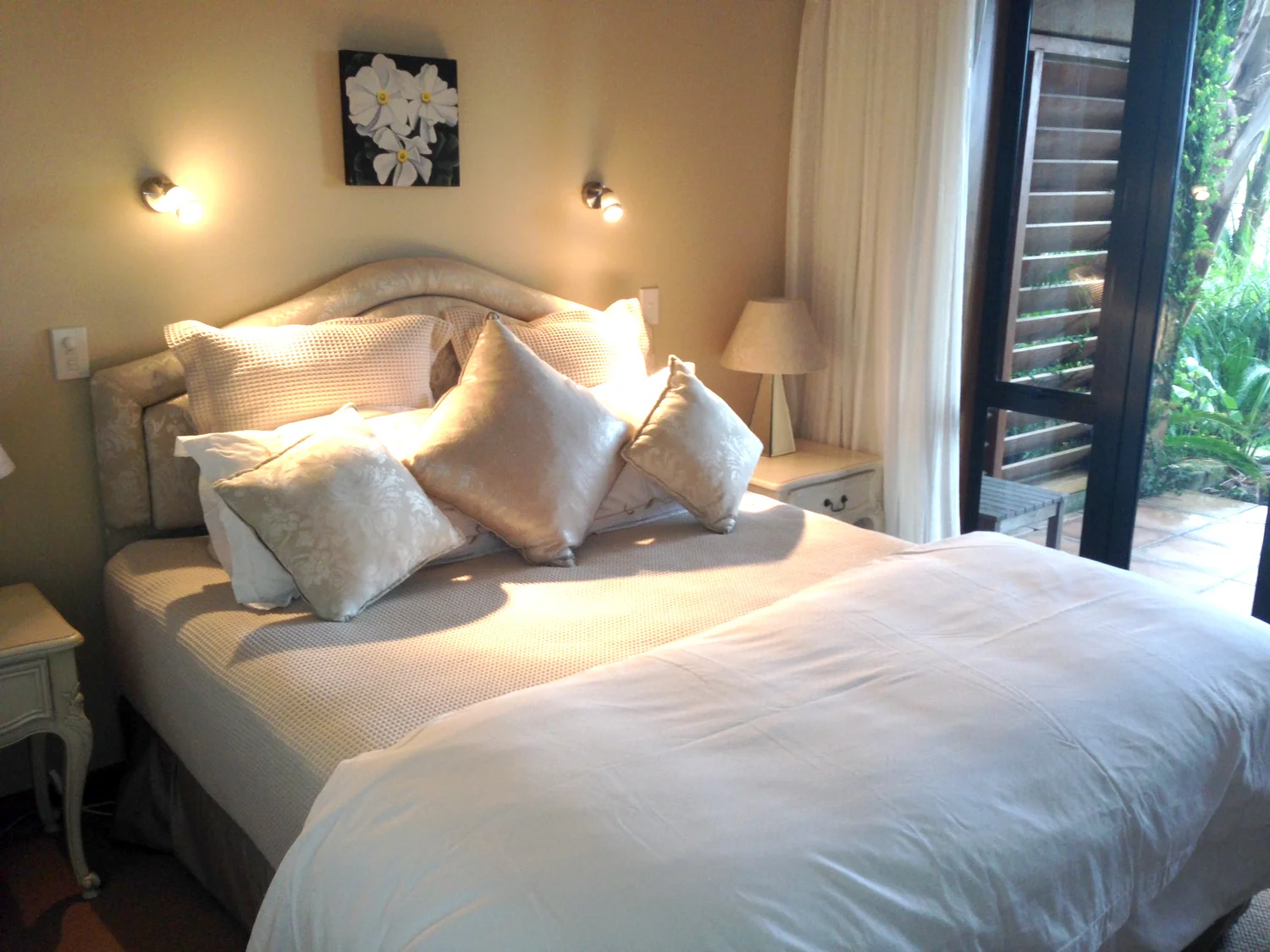 A ground-floor bedroom with doors opening to the garden