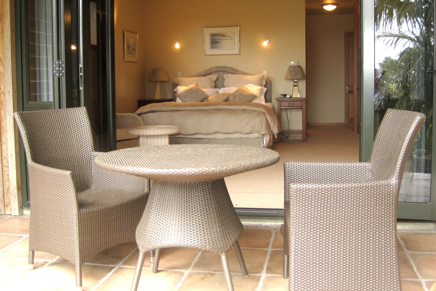 Garden hideaway seen from its patio, bed and seating inside