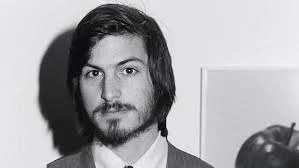 A young Steve Jobs. (Long hair, don't care)