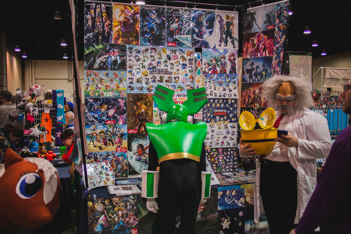 A cosplayer checks out some items in the Dealer Room.