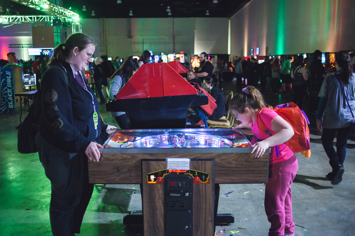 A mother and daughter play head to head pinball
