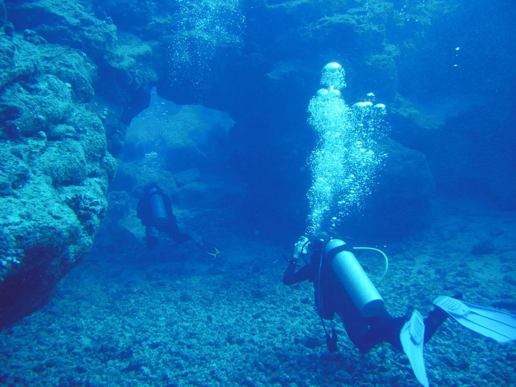 Divers under an arch