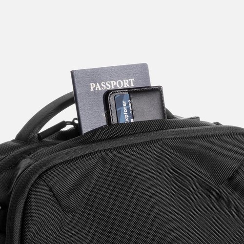 Quick access top pocket for travel documents.