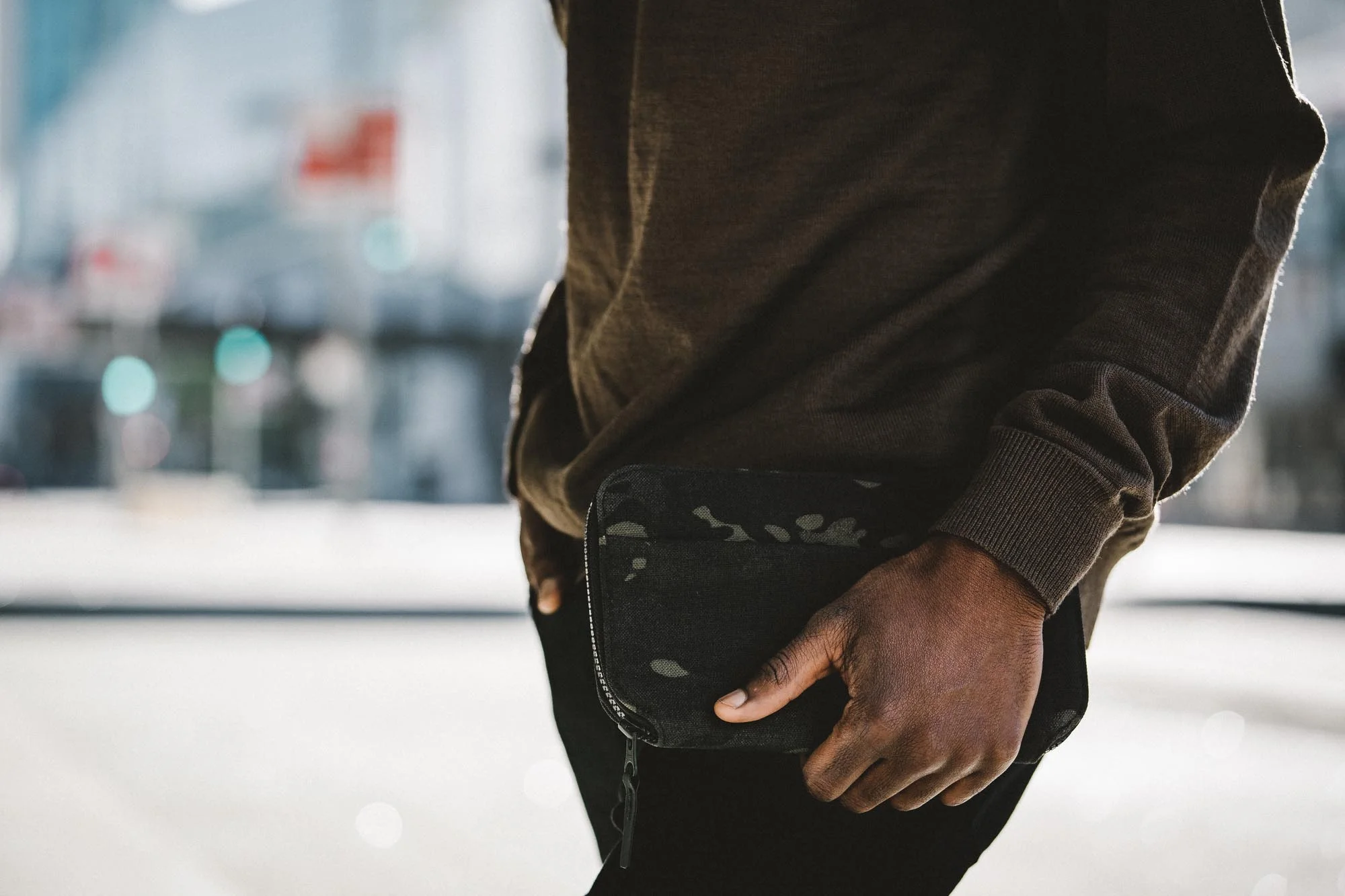 44002_travelzipwallet_blackcamo_model2.jpg
