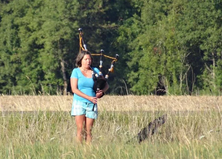 Eclipse chasers took many forms. Here, out standing in a field, was a bagpipe lady near Halsey, Oregon - moments before the eclipse. Photo by Pat Brown