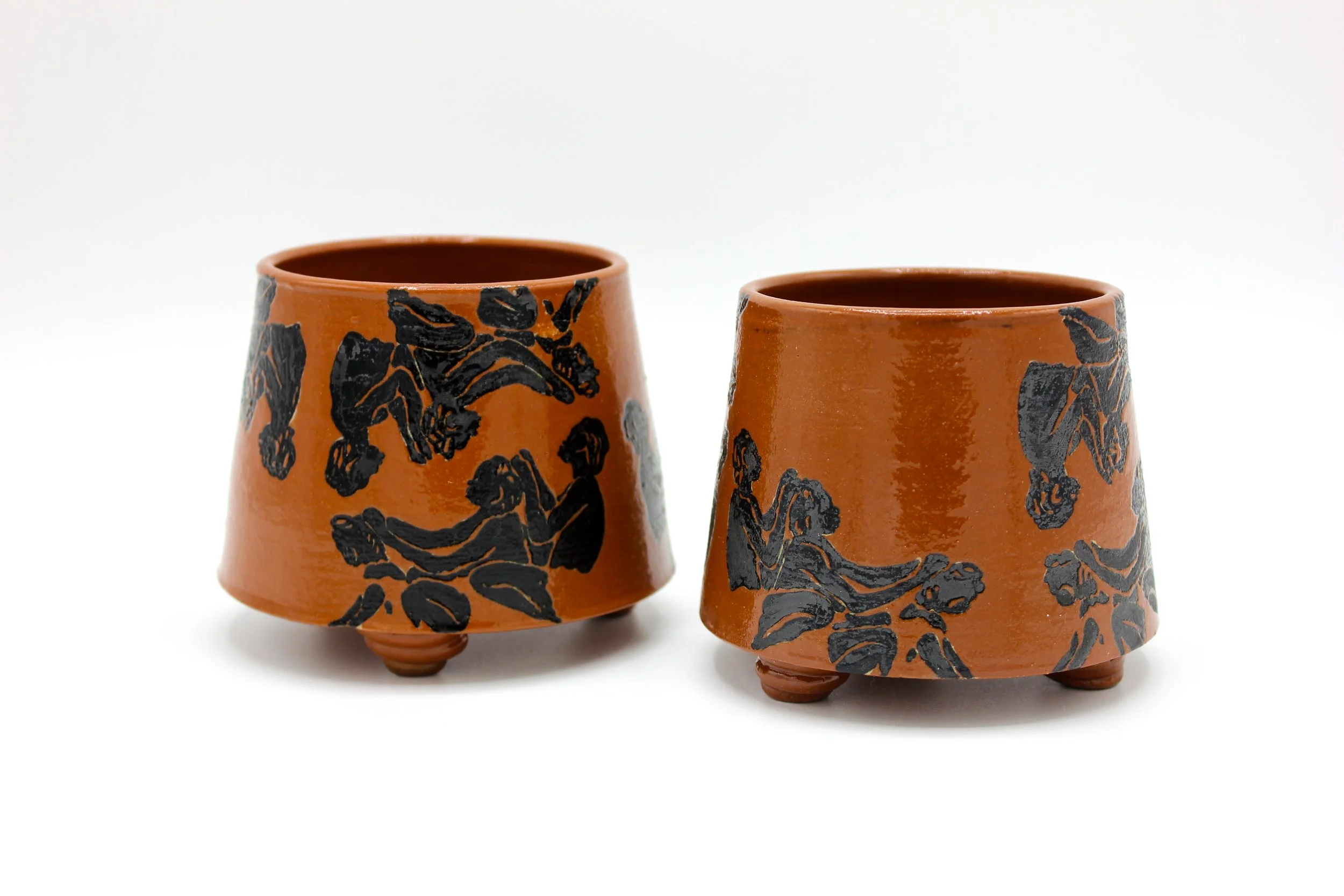 Nala C. Turner,
If We Can't Be Free, Be Braided, Cup I; Underglaze illustration, brick red engobe, wax resist and clear glaze on tan stoneware, 3.5 x 3.5 x 3”, 2026
