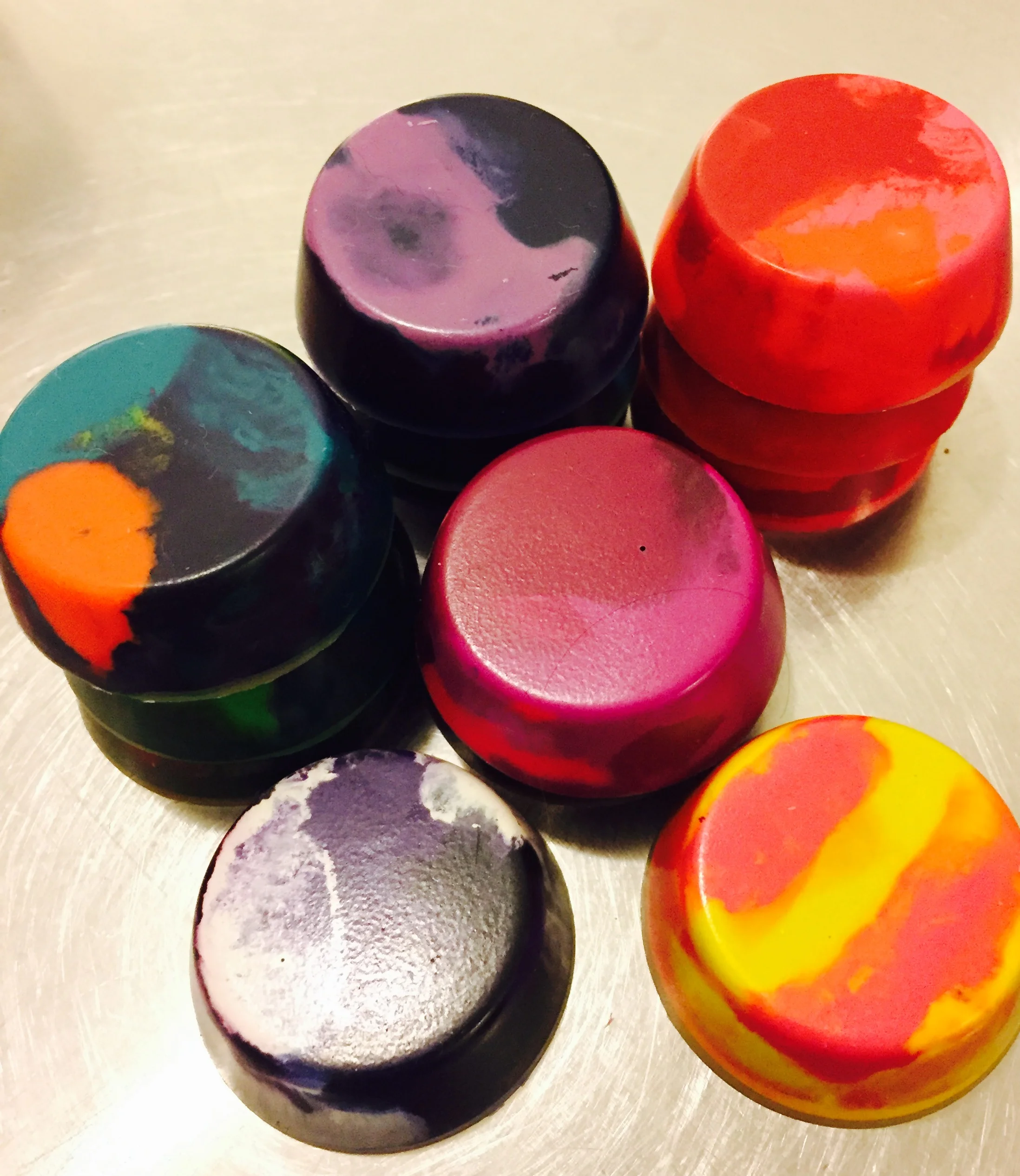 After they are cooled they popped right out of the tin. The results were, well, like mini-muffin shaped crayons with super cool patterns and color combos!