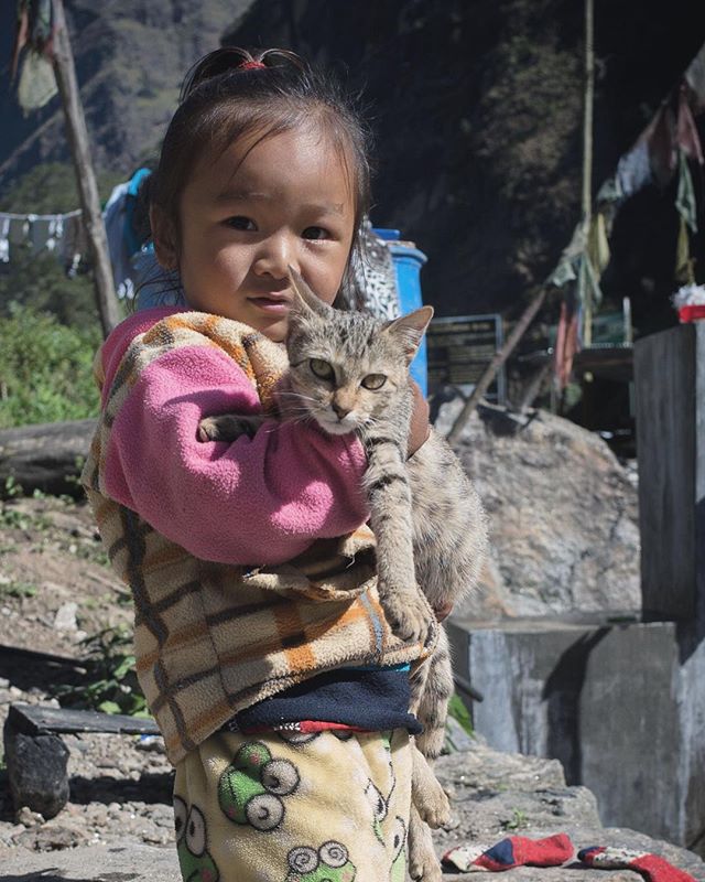 At Chetchet village, first day in the mountains, i smiled watching this girl parade around with her feline friend, who seemed resigned to his fate.