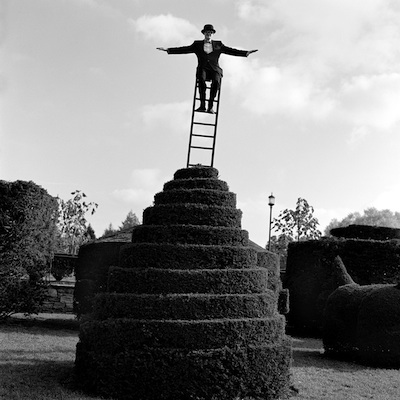   Travis on Ladder Above Hedges, Longwood gardens, Pennsylvania  2002 Silver gelatin print 10.5 x 10.5" (image) 22 x 26" (mount) 