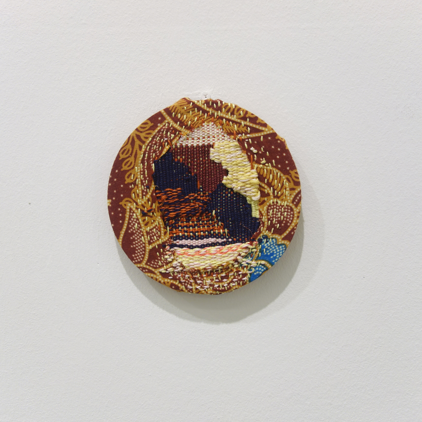 Izziyana Suhaimi, Cross Section of Bone V, 2015, Woven cotton thread darned on found Batik; wooden hoop, Ø13 cm.jpg