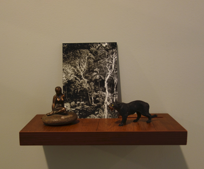  Donna ONG  Postcards from the Tropics (vii)  2016 Diasec print, wooden shelf, and tropical souvenirs (bronze statuette on pebble and vintage wooden panther) Dimensions variable 
