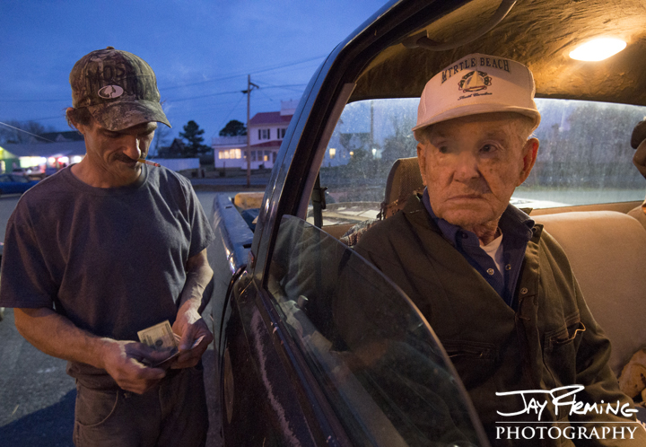 Art Daniels pays his crew after a day of dredging. November 2014