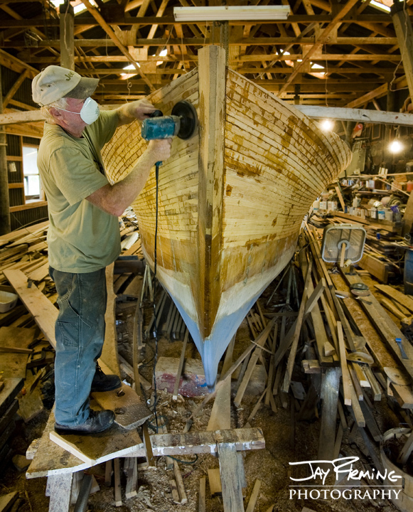 Millard Littlepage sands the bow of his wooden boat. Dorchester County, MD. September 2014