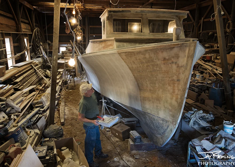 After the strip planked boat was coated with fiberglass, multiple coats of primer paint were added before the top coats of paint