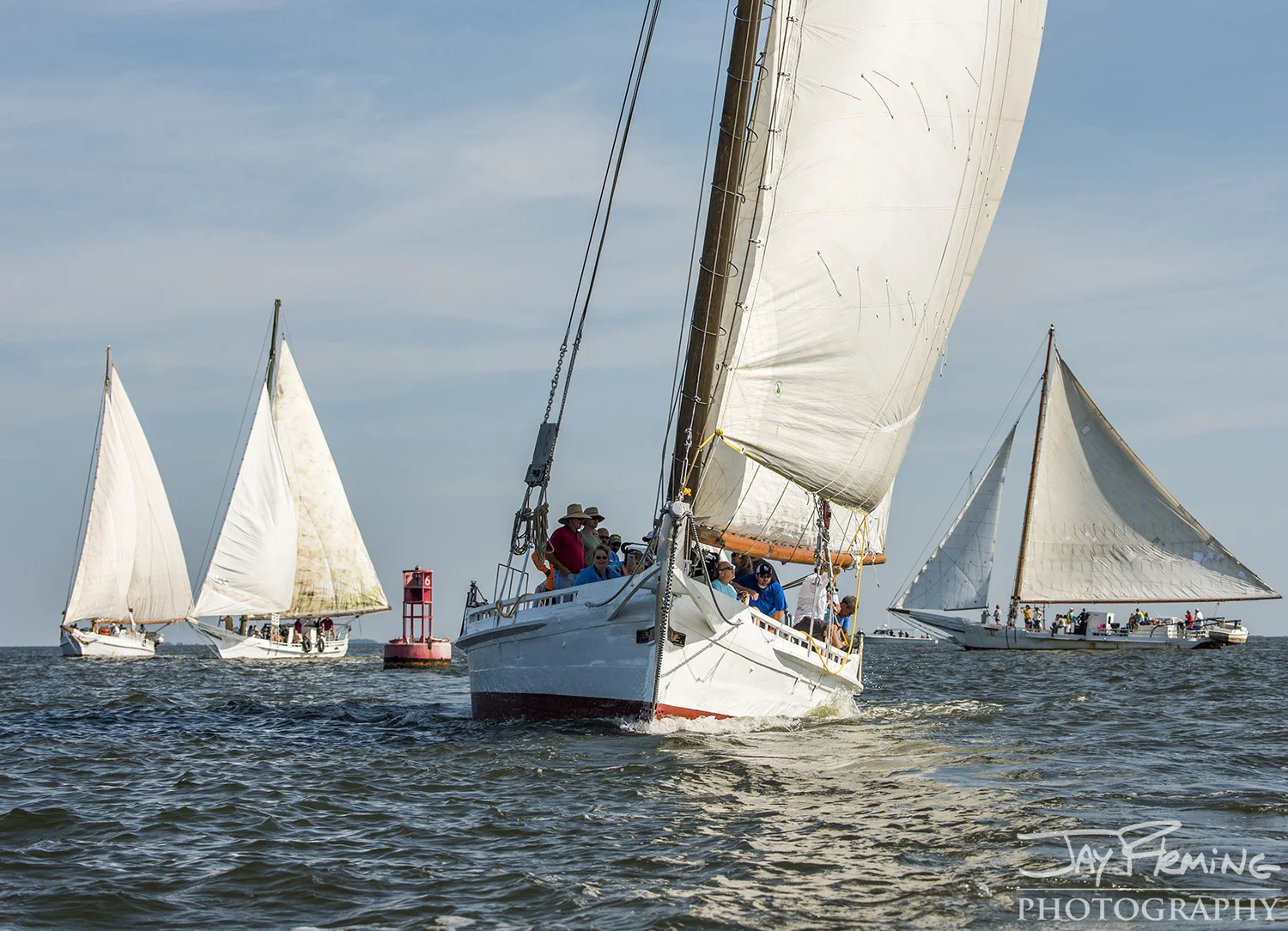 Skipjacks tack around the 16-buoy in Tangier Sound to head south on the second leg of the race&nbsp;