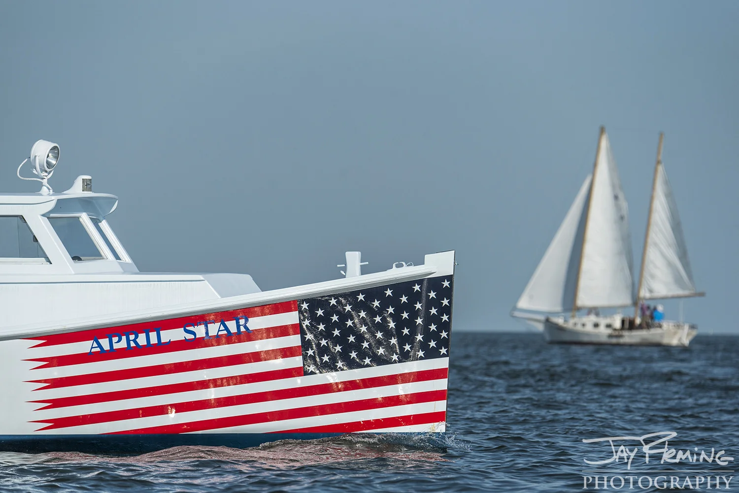 The classic roundstern workboat April Star out of Scott's Cove Marina on Deal Island watches the race with passengers.&nbsp;