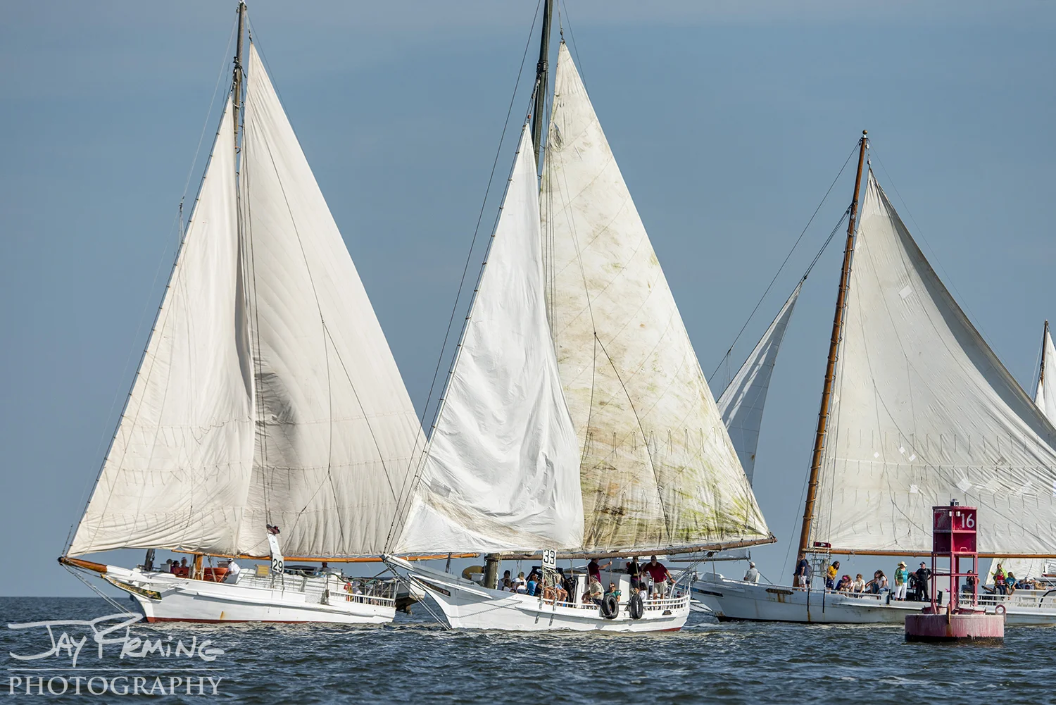 Skipjacks tack around the 16-buoy in Tangier Sound to head south on the second leg of the race