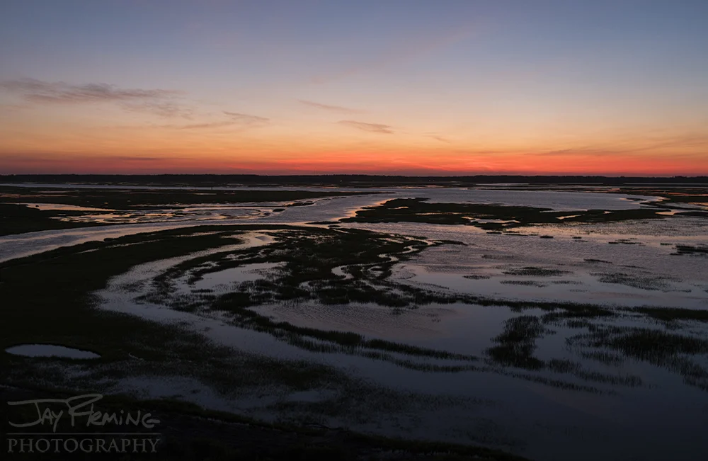 Sunset light over the marsh looking west from Cedar Island to Folly Creek. 